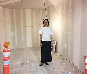 UX Designer Monica Ong Reed standing in her future office